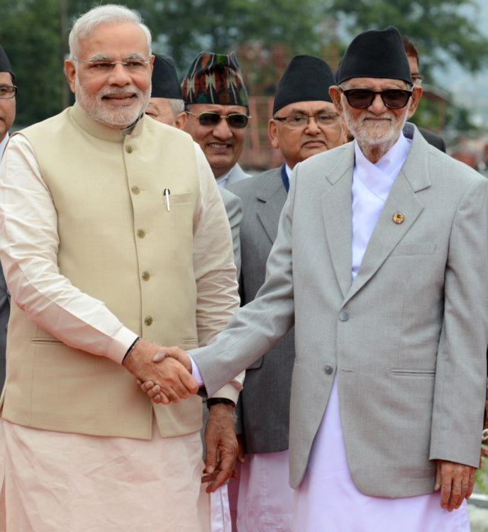 Nepalese Prime Minister Sushil Koirala (R) shakes hands with Indian Prime Minister Narendra Modi on his arrival at Tribhuvan International Airport in Kathmandu on August 3, 2014. India's premier Narendra Modi arrived in Nepal on a visit intended to ramp up Indian engagement and deepen trade ties while countering China's growing influence in the region. AFP PHOTO/Prakash MATHEMA (Photo credit should read PRAKASH MATHEMA/AFP/Getty Images)